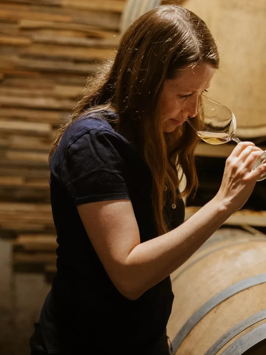Céline nosing a glass in the cellar