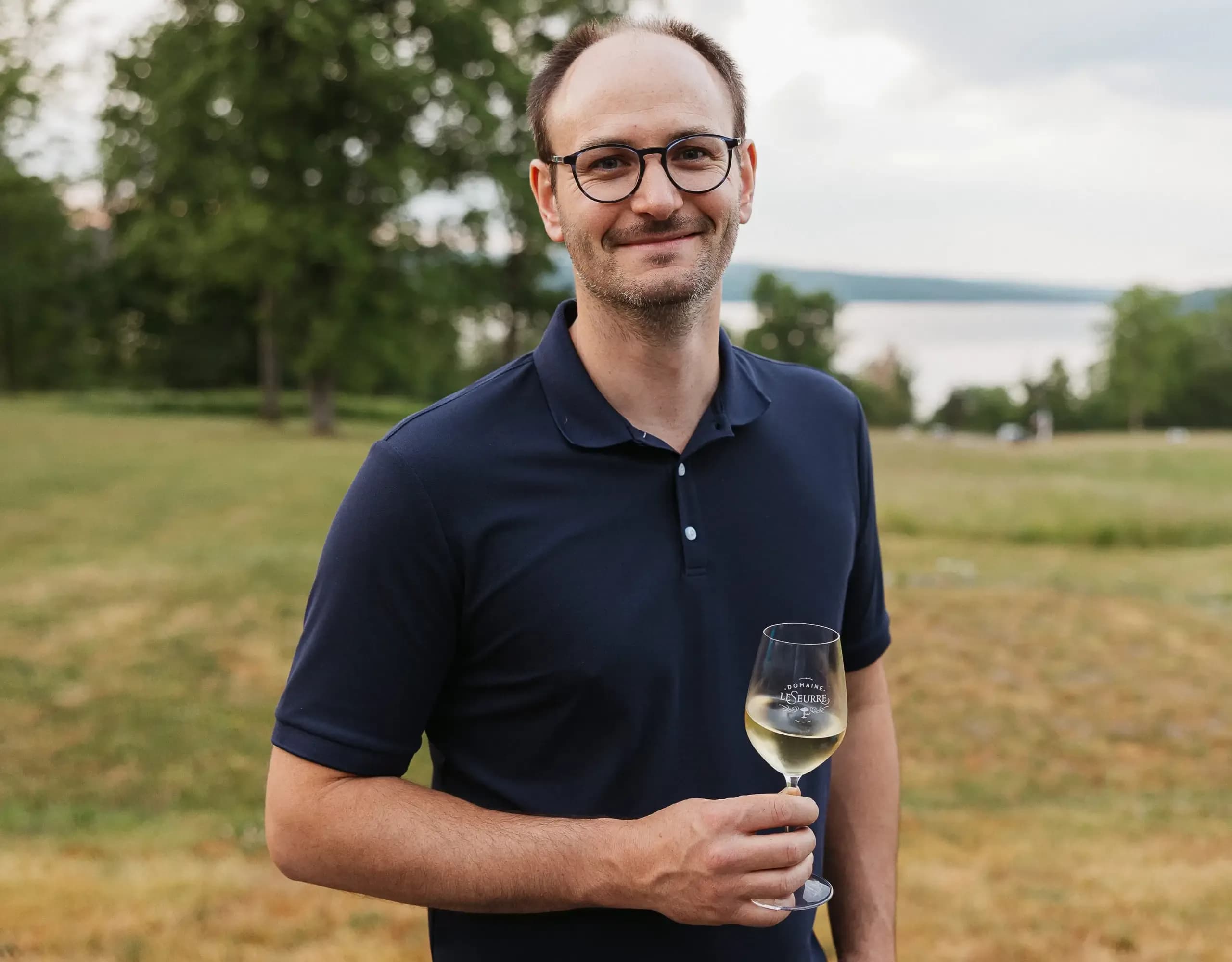 Sébastien with a glass by Keuka Lake