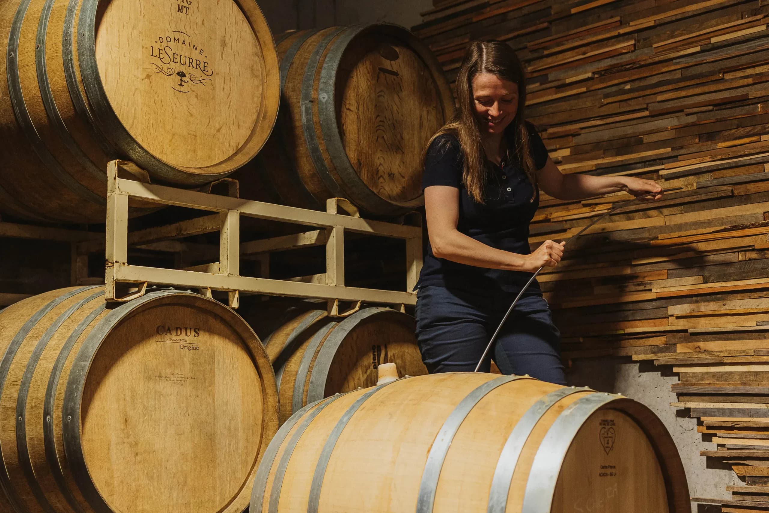 Céline drawing wine from the barrel