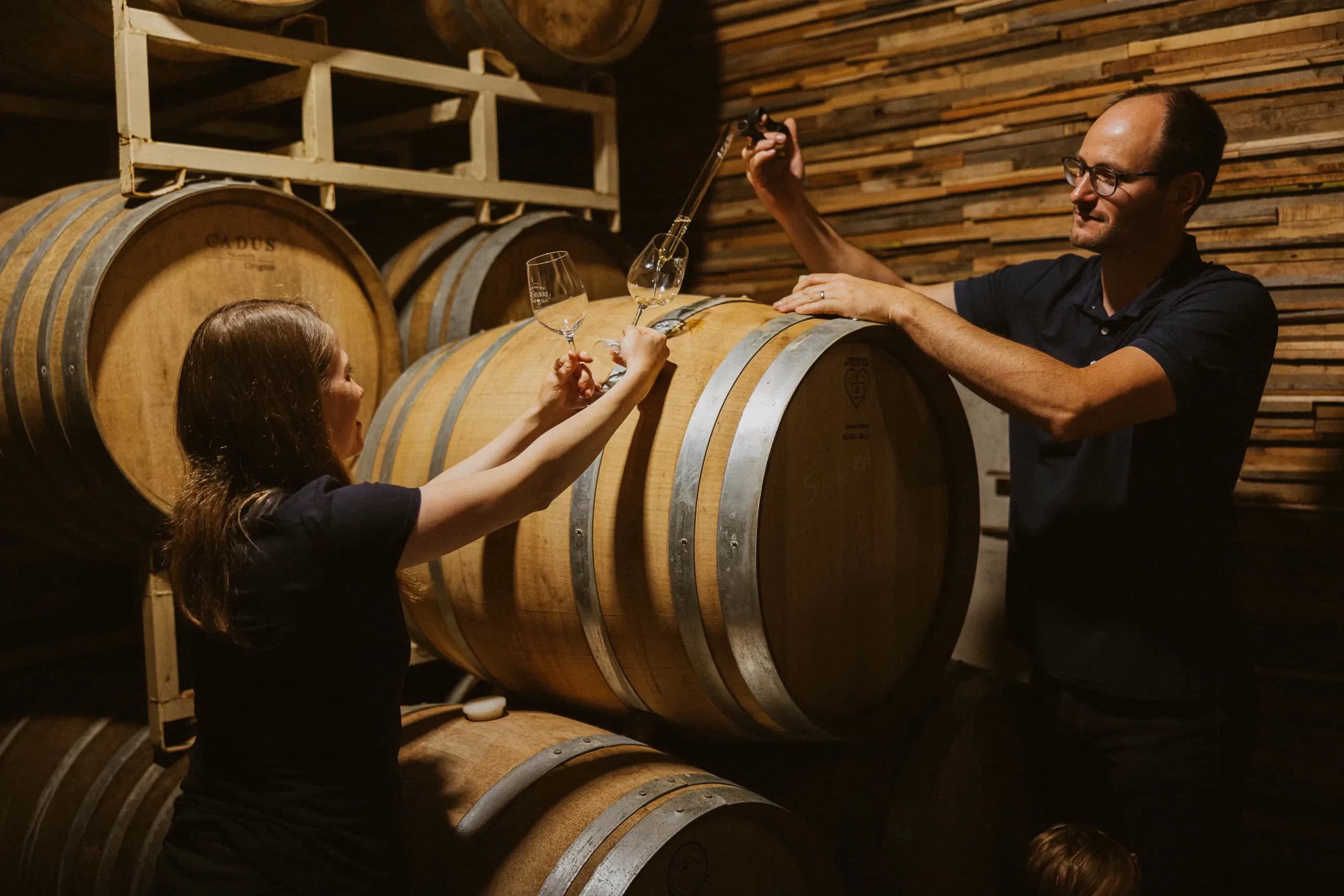Céline and Sébastien making wine together in the cellar